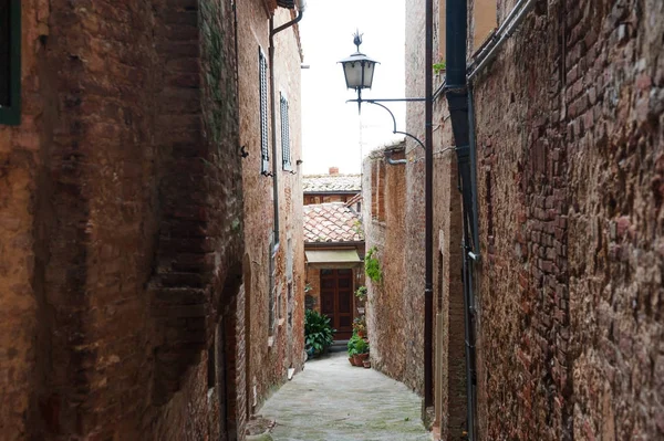 Средневековая узкая улочка в историческом центре города Монтепуличано недалеко от Сиены, Тоскана, Италия — стоковое фото