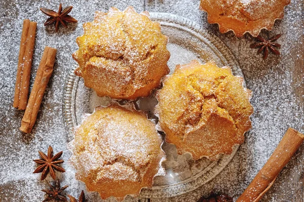 Sweet pumpkin muffins covered with icing sugar