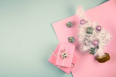 Pembe ve mavi neo arkaplanda topları olan beyaz, yükselen köknar ağacıyla 2020 minimalist modern Noel afişi. Minimum şenlikli Noel düzlüğü