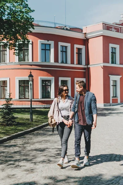 Travel couple, Romantic Destinations, Weekend Getaways, honeymoon for Couples. Happy young travellers woman and man with backpacks walks the streets of the city.