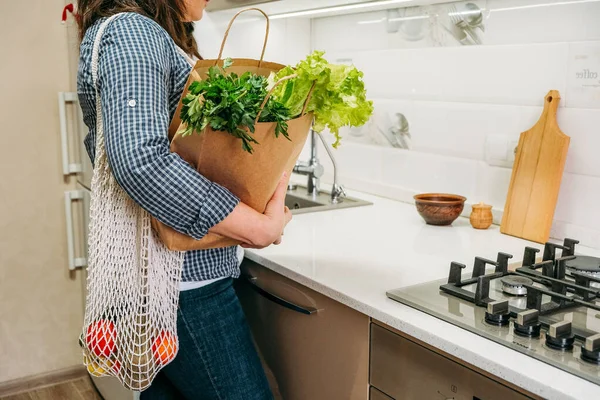 Whole Foods, Plant based diet ingredients in eco friendly zero waste packaging. Fresh raw food seasonal vegetables on home kitchen. Vegetarian, vegan food cooking ingredients.