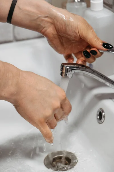 Hand hygiene. How to Wash Your Hands with soap and water. Women washing hands with antibacterial soap at home bathroom. Prevent the spread of germs