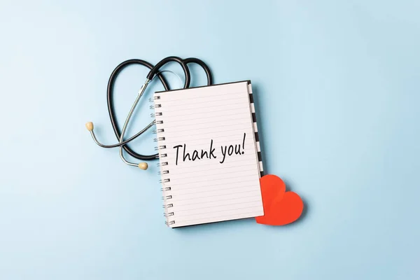 Thank you to doctors, nurses, medical workers. HAPPY NURSES DAY background, banner. International Nurses Day Healthcare and medical concept with notebook, heart and stethoscope