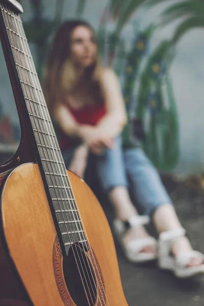 Learning to play the guitar. Beginner Guitar Lesson. Close-up of female hand playing Acoustic guitar. Music education and extra-curricular lessons.