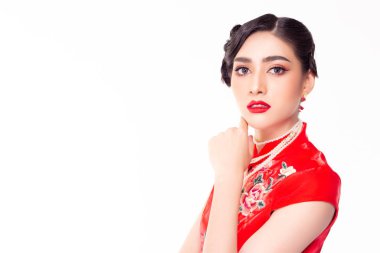 Portrait charming beautiful young Chinese woman. Attractive beautiful asian lady apply beautiful makeup, red lips, nice hairdo. Pretty girl wear Chinese dress. China female has beauty facial skin