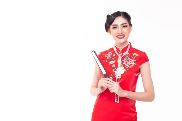 Portrait charming beautiful young Chinese woman. Attractive beautiful young asian lady wears Chinese dress, apply beautiful makeup, nice hairdo, holding Chinese fan in Chinese New Year day. Copy space — Stockfoto