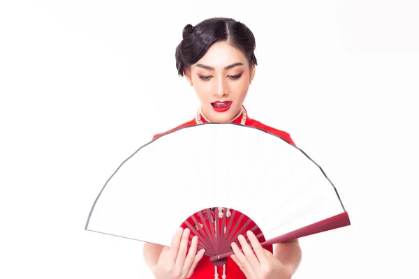 Beautiful young asian woman wear Chinese dress, look at Chinese fan in Chinese New Year. Attractive beautiful Chinese woman get surprised, happy. She look copy space, product, goods for advertising — Stockfoto