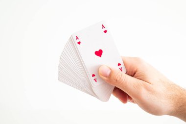 Deck of play cards held by Caucasian male hand front facing Ace
