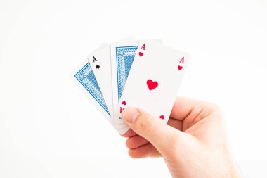 Play cards two Aces and two folded cards held in hand by Caucasi