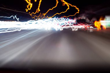 Abstract colorful dizzy car light trails taken at night on rural