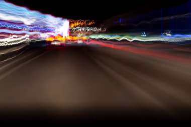 Abstract colorful dizzy car light trails taken at night on rural
