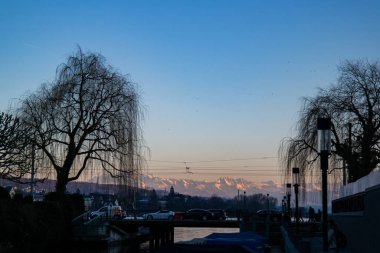 Bunch of covered docked small boats on the river Limmat in Zuric