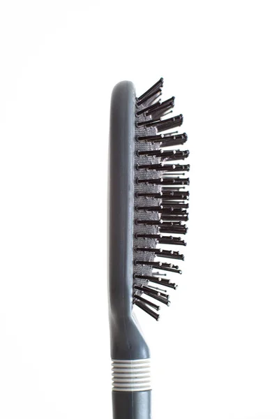 Grey well-used hair brush with handle and visible signs of wear — Stok fotoğraf