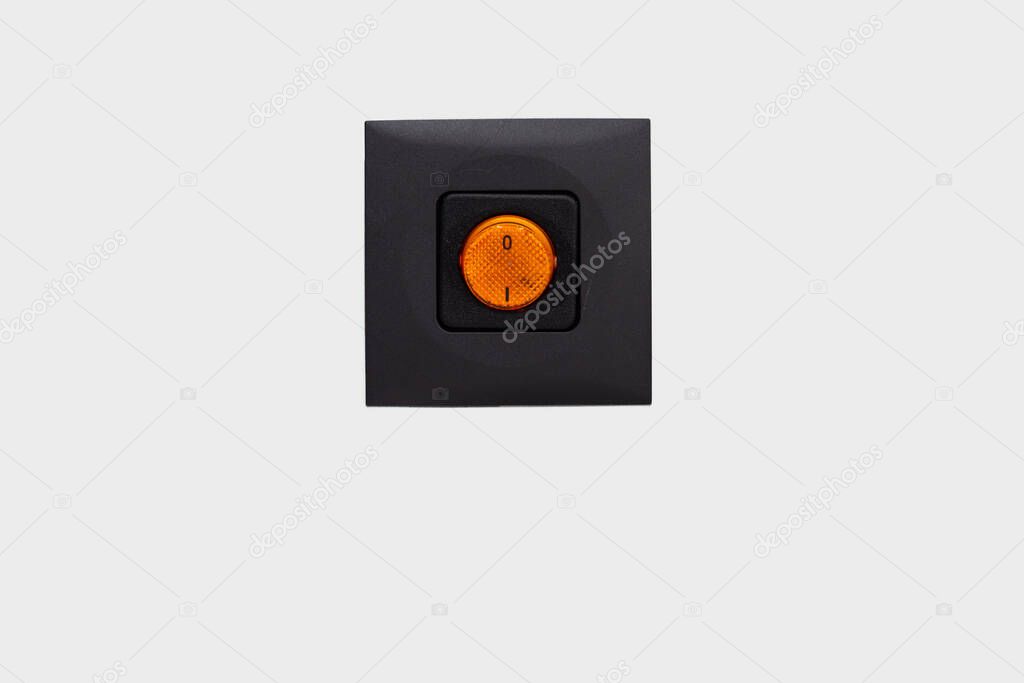 Bright orange electrical switch on brown case close up frontal shot isolated on gray background 2020