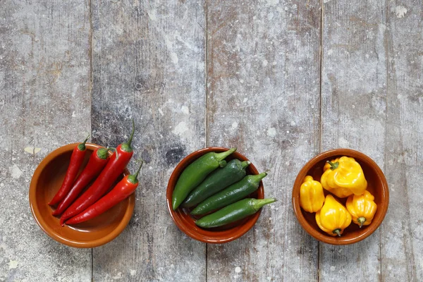 Red Green Yellow Hot Peppers Bowls Old Wooden Table Copy — Stock Photo, Image