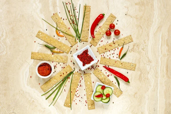 Cheese cracker snack with tomato pesto, danish blue cheese and cucumber - copy space