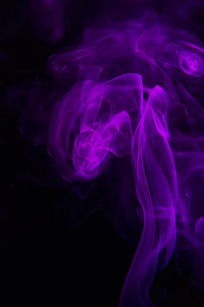 Abstract shape of purple smoke on black background.