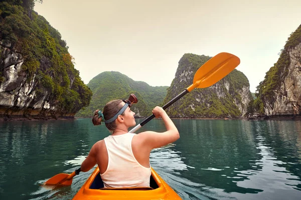 Mujer remando kayak en bahía tranquila entre pintoresco karst mountai — Foto de Stock