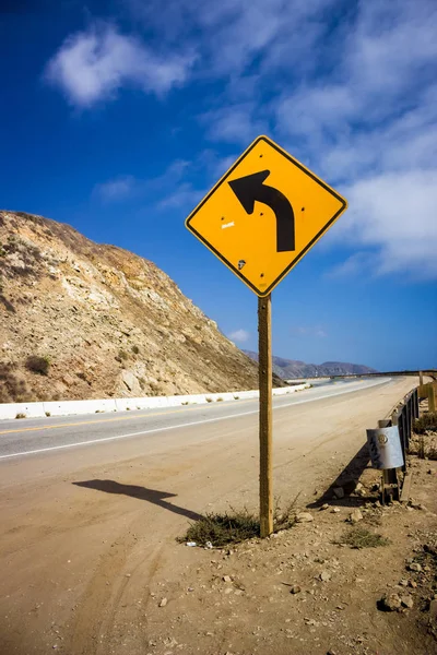 Yellow left turn sign