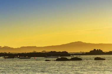 Alacakaranlıkta kayalık sahil