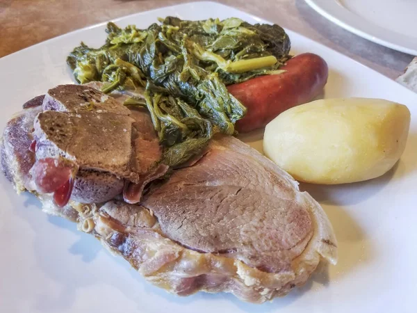 Cooked pork shoulder with rapini, sausage and potatoe, traditional galician recipe