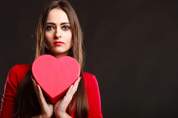 Girl in red holding heart box. — Stock Photo, Image