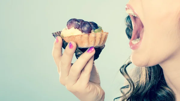 Woman face profile open mouth eating cake — Stock Photo, Image