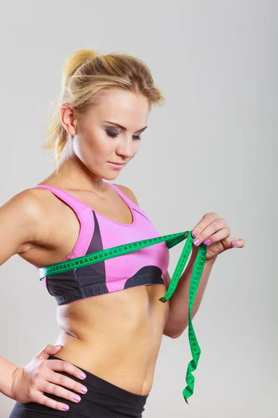 Fit woman measuring her chest breasts with tape measure — Stock Photo, Image