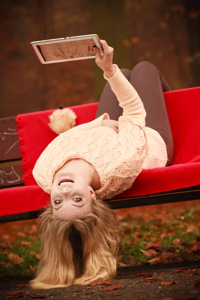 Lány ül a padon tabletta. — Stock Fotó