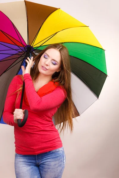 Donna in piedi sotto ombrello multicolore — Foto Stock