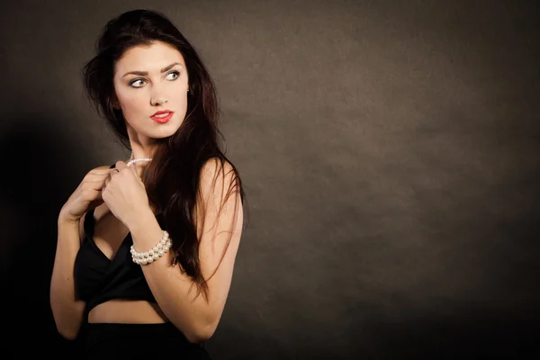 Woman in sensual black dress on dark — Stock Photo, Image