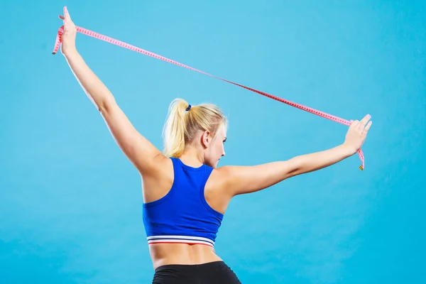 Sporty smiling girl with measuring tape — Stock Photo, Image