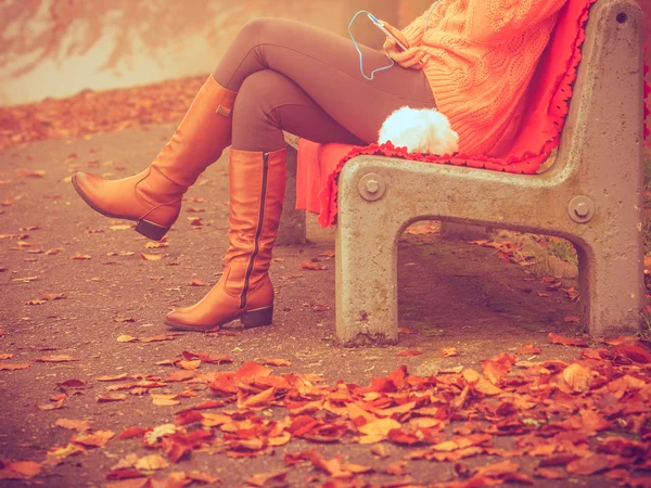 Girl listening to music in autumn park — Stock Photo, Image