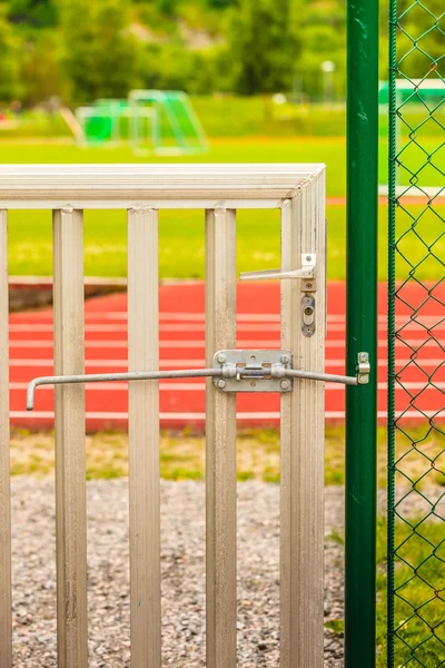 Padlock locked on stadium gate — Stock Photo, Image