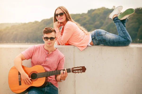 Gelukkige paar met gitaar buiten — Stockfoto