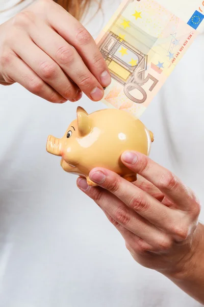 Male hands with banknote and piggybank — Stock Photo, Image