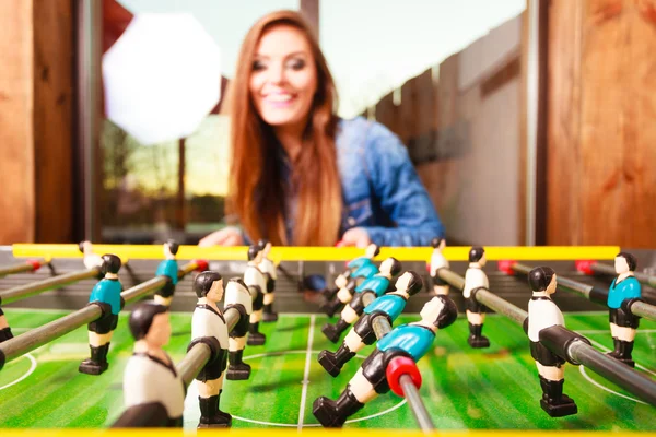 Woman playing table football game — Stock Photo, Image