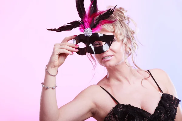 Woman middle aged holds carnival mask. — Stock Photo, Image