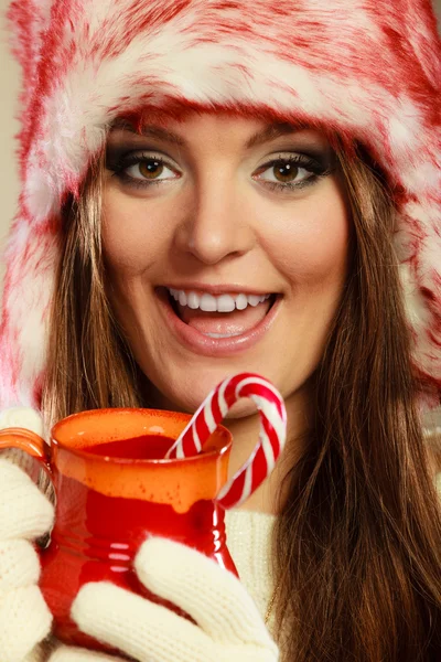 Christmas girl with mug and cane. — Stock Photo, Image