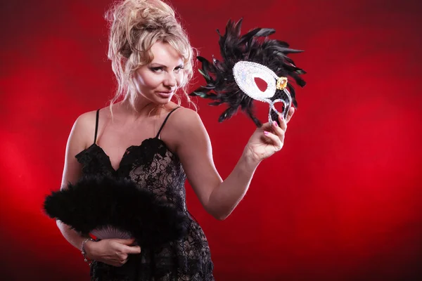 Woman holding carnival mask feather fan in hand — Stock Photo, Image