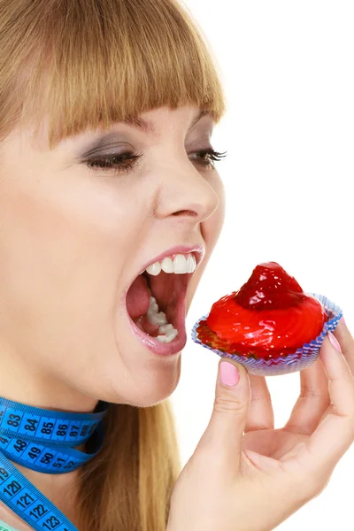 Nő tart cupcake próbál ellenállni a kísértésnek — Stock Fotó