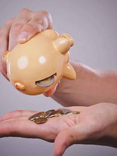 Male hands with coins and piggybank — Stock Photo, Image