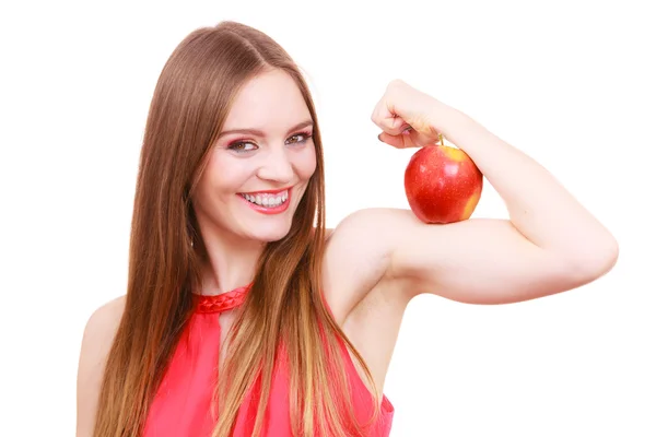 Woman fit girl holds apple fruit on her biceps arm — Stock Photo, Image