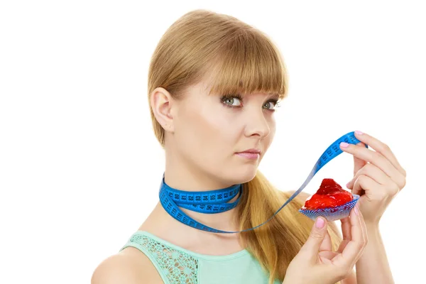 Woman holds cupcake trying to resist temptation — Stock Photo, Image