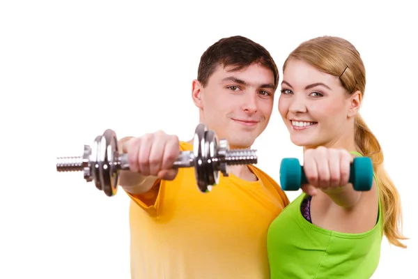 Couple exercising with dumbbells lifting weights Stock Photo