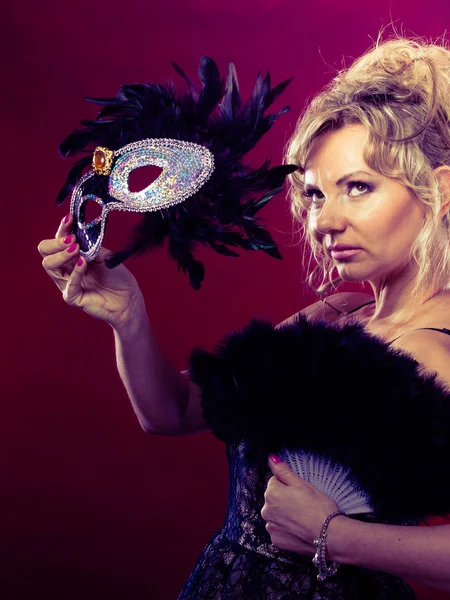 Woman holding carnival mask feather fan in hand — Stock Photo, Image