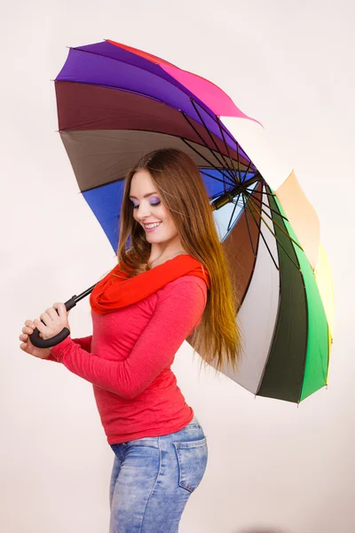 Frau steht unter buntem Regenschirm — Stockfoto