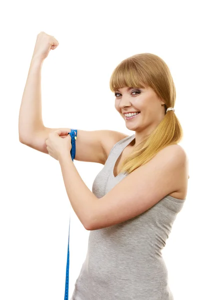 Woman fit girl with measure tape measuring her biceps. — Stock Photo, Image