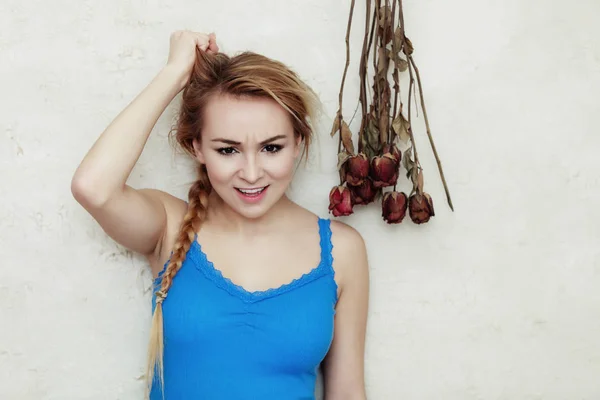 Blond woman teenage girl showing her damaged dry hair — Stock Photo, Image