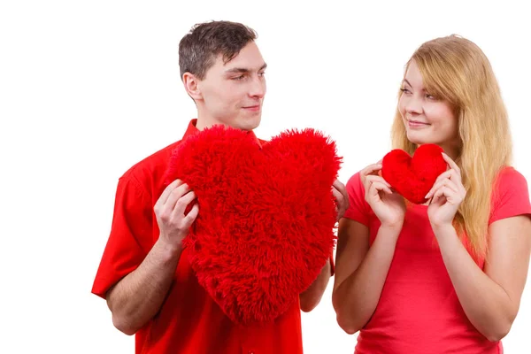 Couple holds red heart shaped pillows love symbol — Stock Photo, Image